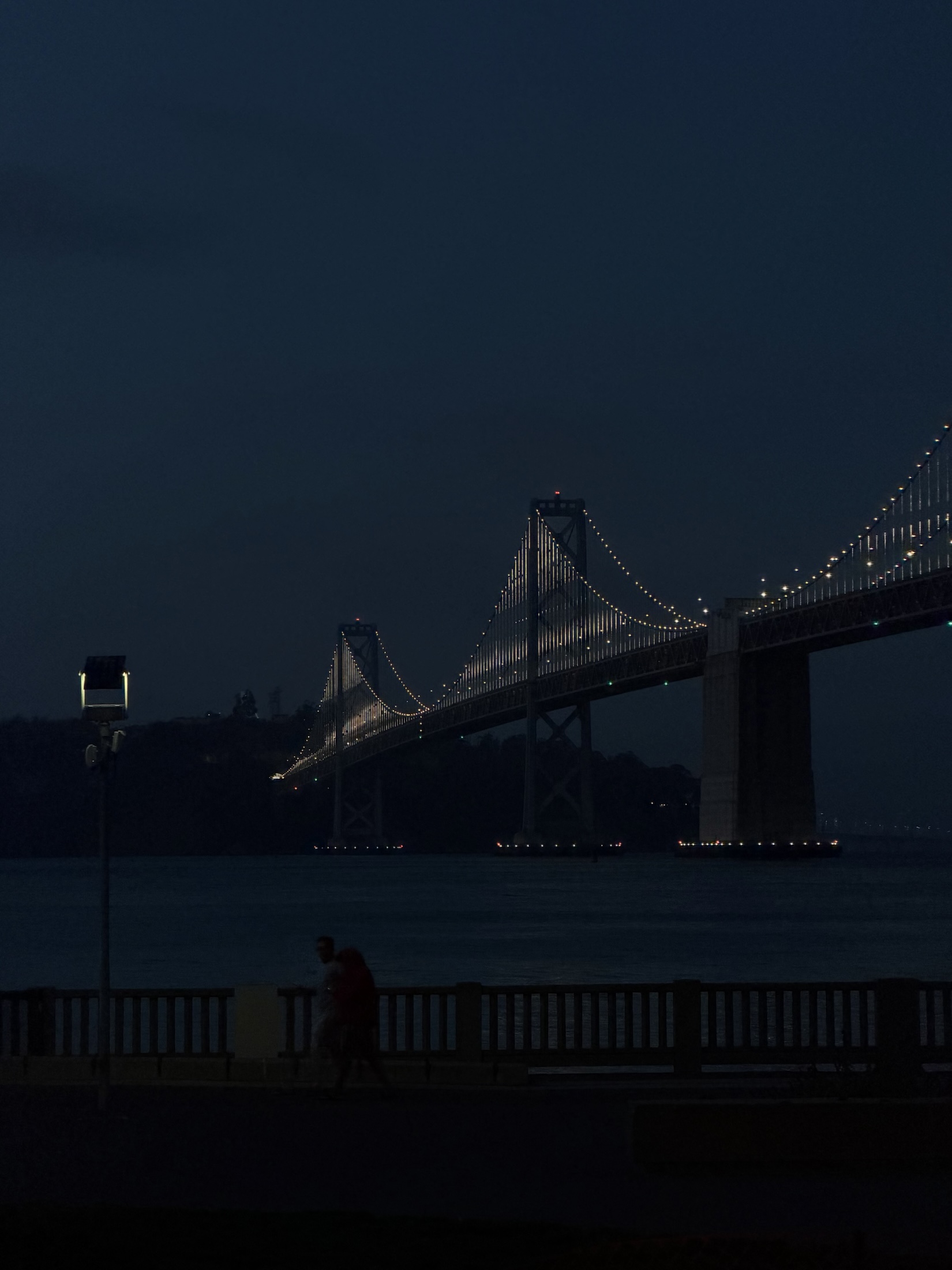 The Bay Bridge at blue hour, reflected over the water